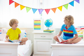 Wall Mural - Child reading in bed. Kids read. Boy at home.