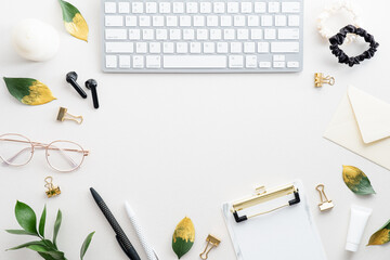 Fototapete - Flat lay, top view office table desk. Feminine workspace with keyboard, glasses, earphones, clipboard and office supplies.