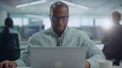 Poster - Office: Portrait of Confident IT Programmer Wearing Headphones Working on Computer, Looking at Camera and Smiling. Black Male Software Engineer Developing Innovative App, Program, Video Game. Zoom In