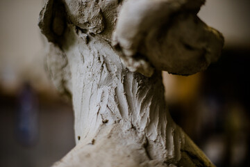 Fingerprints on the clay sculpture of female head in progress in art studio
