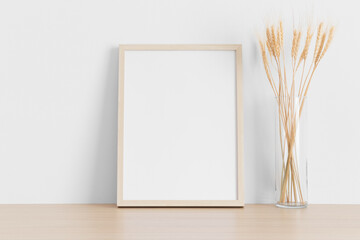 Wall Mural - Wooden frame mockup with dried flowers on the wooden table.