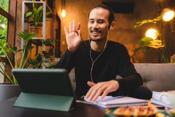 Wall Mural - young man person using computer laptop or tablet for work and learning online communication from home, cyberspace education technology for business people or student using to work, hipster businessman