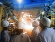 © sittinan - Engineer group control welding robotics automatic arms machine in factory automotive industrial with monitoring system software. Digital manufacturing operation.