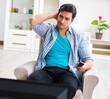 © Elnur - Man watching tv at home