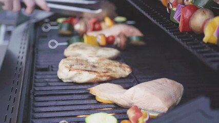 Wall Mural - Grilling an Atlantic salmon, chicken breast, vegetable skewers, and vegetarian burgers on an outdoor grill.