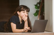© Alena Yakusheva - portrait of adorable child girl doing on-line learning using laptop at home, home schooling, online education