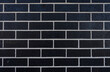 Black brick wall with white mortar.