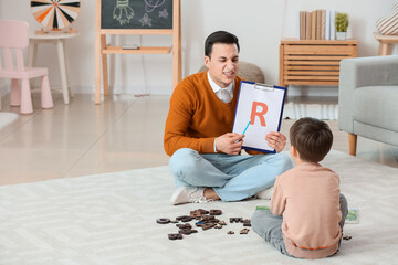 Poster - Speech therapist working with little boy in office