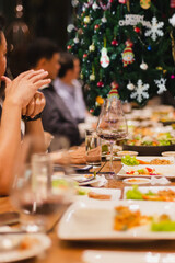 Holiday celebration concept friends having Christmas dinner party and drinking red wine indoor.