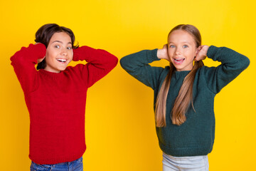 Canvas Print - Portrait of attractive stunned cheerful couple closing ears having fun isolated over bright yellow color background