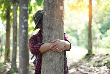 Concept : Love Nature. Male Botanist Is Hugging Tree In Forest.     