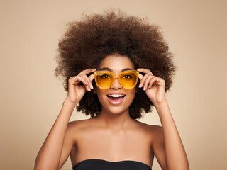 Wall Mural - Beauty portrait of African American girl in colored sunglasses. Beautiful black woman. Cosmetics, makeup and fashion