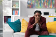 © ABCreative - Distraught, sad bisnessman dressed in a suit sits on sofa in office covers face with hand, crying business collapse loss of money failure at work dark-skinned man is worried having worse day stress