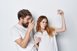 © SHOTPRIME STUDIO - cheerful young couple in white t-shirts emotions Positive friendship