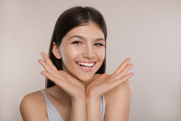 Wall Mural - Portrait of pretty girl on light background. Beautiful face with perfect smooth skin