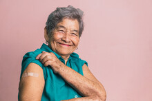 Aged Woman With Plaster On Arm After Vaccination From Coronavirus