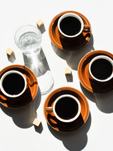 Overhead View Of Espresso Cups And Glass Of Water
