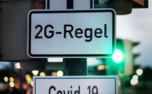 2G Rule Vaccinated And Recovered On A Traffic Sign With A Green Light, Symbol For Entry Only After 2 G Covid-19 Rule