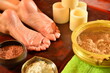 © Sergey - Ayurvedic foot massage with oil on the wooden table in traditional style. Top view.