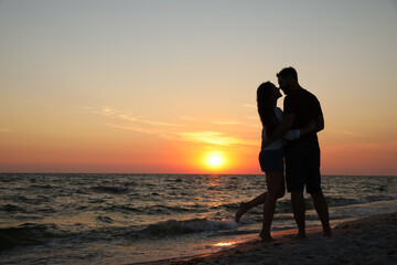 Sticker - Couple spending time together on beach at sunset