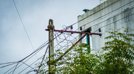 Wall Mural - Closeup of the messy wires on a transmission pole outdoors