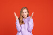 © Lustre Art Group  - Half-length portrait of young beautiful girl showing irritation isolated on red studio background. Concept of human emotions