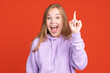 © Lustre Art Group  - Cropped portrait of young excited girl raising finger up isolated on red studio background. Concept of human emotions