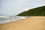 Fototapeta Do akwarium - Ocean-Sea Waves Beach Sand and Mountains Yellow Landscape Background