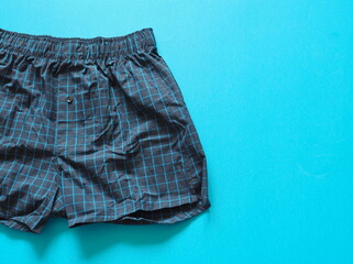 Men's underwear on a blue background. Classic cotton boxer shorts. Place for text