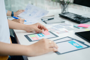 Creative Web Designer planning application and developing template layout, framework for mobile phone. User experience (UX) concept.