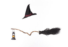 Black Broom And Witch Hat Isolated On White Background