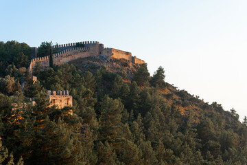 Wall Mural - Alanya, Turkey. Beautiful view from the fortress Alanya Castle of the Mediterranean Sea and beach at sunset. Vacation evening.