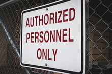 Authorized Personnel Only Sign On Fence