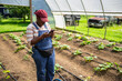 © Creative Flame - Female farmer using smart phone in greenhouse