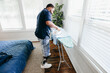 © Creative Flame - Black man ironing clothes, everyday life, disabled