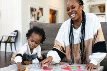 Black Mother And Kids Put Together Africa Puzzle 