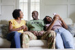 © Creative Flame - Black couple with preteen daughter on sofa