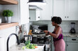 © Creative Flame - Black woman cooking at home, healthy vegetables