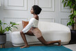 © Creative Flame - Young woman doing lunge yoga pose in living room