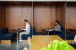 © Creative Flame - Diverse business people working in modern office booths