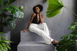 © Creative Flame - Elegant young woman sitting on steps among plants