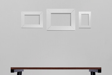 White pictures frame, Vertical and horizontal hanging on a gray wall.