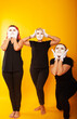 © Marina Chernivetskay - girls in white masks and white gloves in the image of mimes an unseen wall show hands actors of theater and cinema, the concept of advertising a shopping center