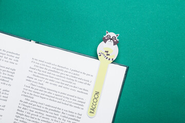 Wall Mural - Cute bookmark with book on color background