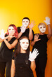 © Marina Chernivetskay - girls in white masks and white gloves in the image of mimes an unseen wall show hands actors of theater and cinema, the concept of advertising a shopping center