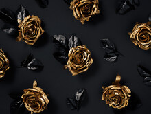 Dark Romantic Pattern With Beautiful Golden Roses With Black Leaves Isolated On A Black Background. Creative Floral Concept. Flat Lay.