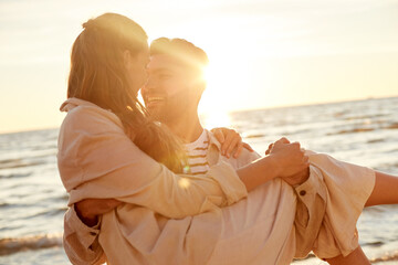 leisure and people concept - happy couple having fun on summer beach