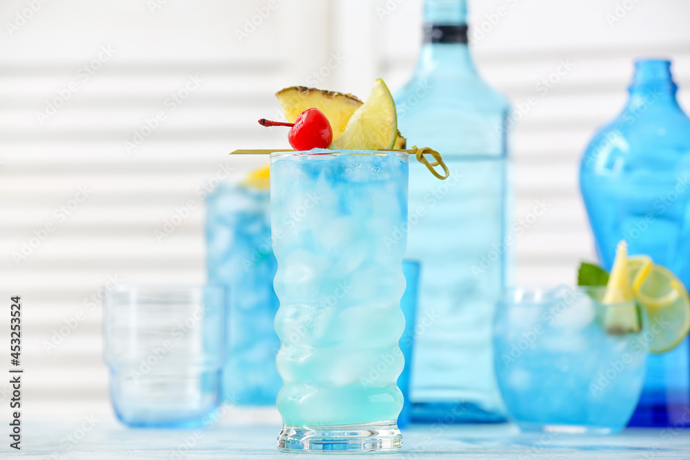 Glasses of Blue Lagoon cocktail on table in room