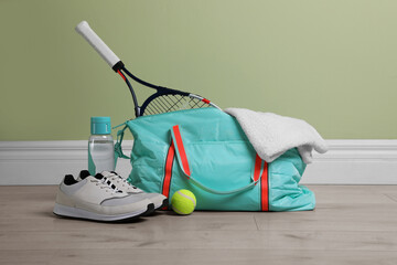 Wall Mural - Bag with different sports equipment on wooden floor indoors