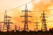 © Vadim - Shadows of high voltage electric lines. Sunset silhouette energy constructions.
